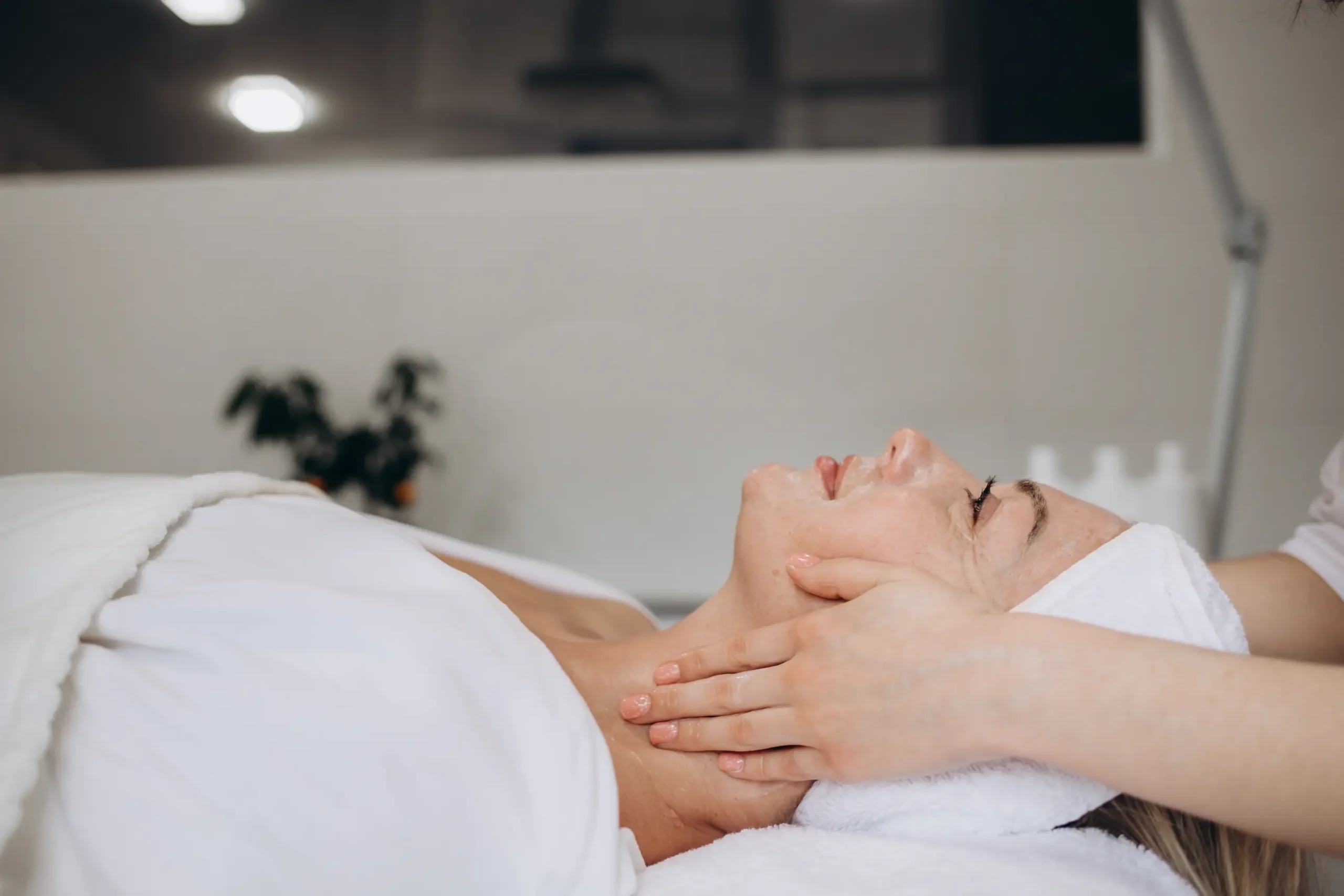 A client unwinds during facial treatments at La Maison Beauté, receiving a soothing massage that promotes relaxation and enhances her skin's natural radiance. It's a moment of pure self-care."