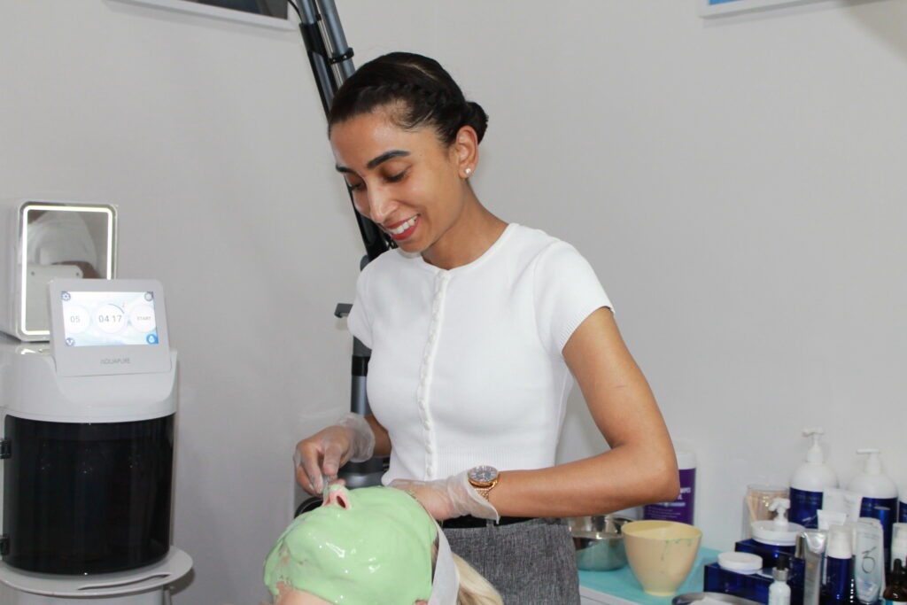 Anushka applying a soothing facial mask on her client's
